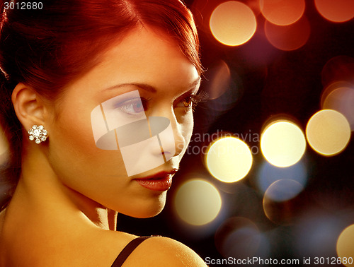 Image of woman in evening dress wearing diamond earrings