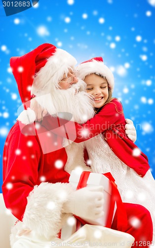 Image of smiling little girl with santa claus