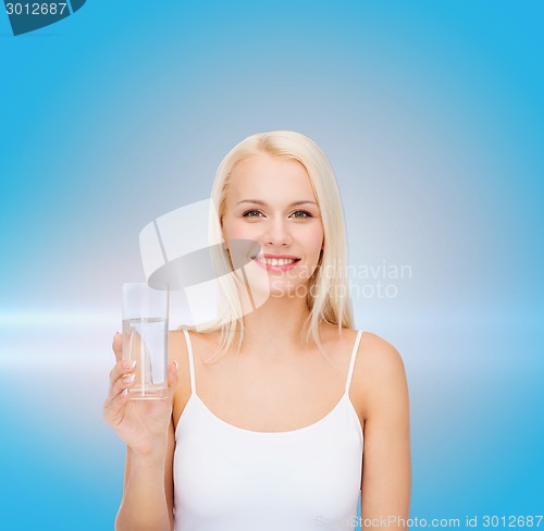 Image of young smiling woman with glass of water