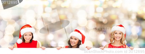 Image of women in santa helper hat with blank white board