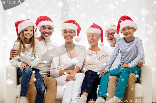 Image of happy family sitting on couch at home