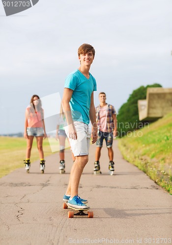 Image of group of smiling teenagers with roller-skates