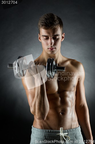 Image of young man with dumbbell