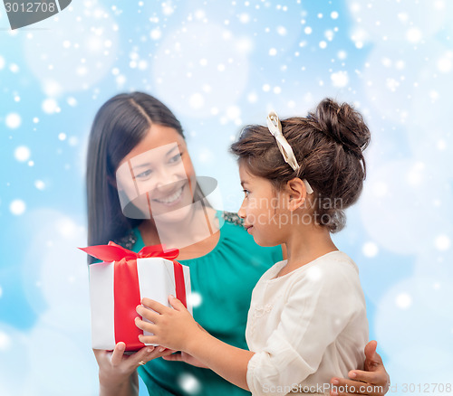 Image of happy mother and child girl with gift box