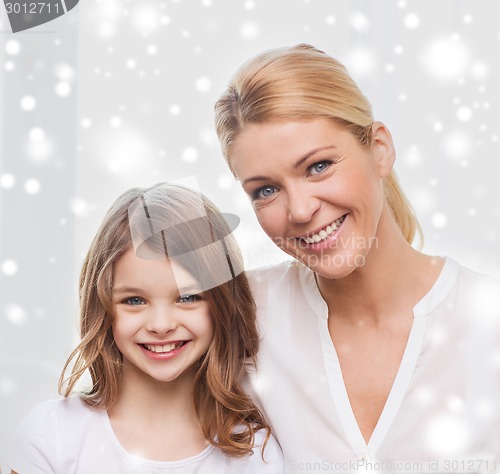 Image of smiling mother and little girl