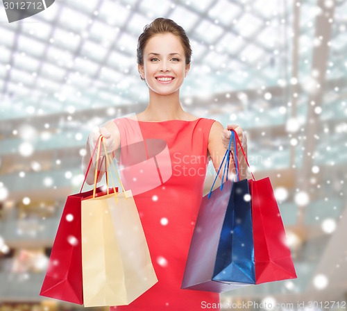 Image of smiling woman with colorful shopping bags