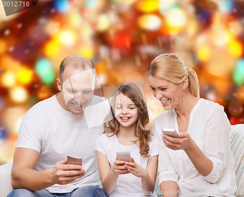 Image of happy family with smartphones