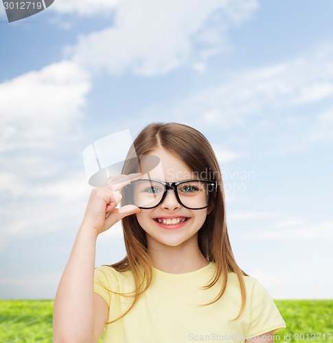 Image of smiling cute little girl in black eyeglasses