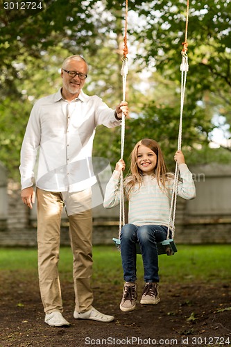 Image of happy family in front of house outdoors