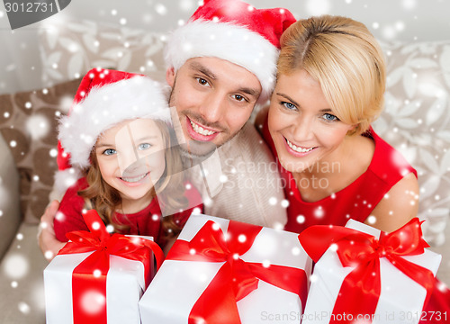 Image of smiling family holding many gift boxes