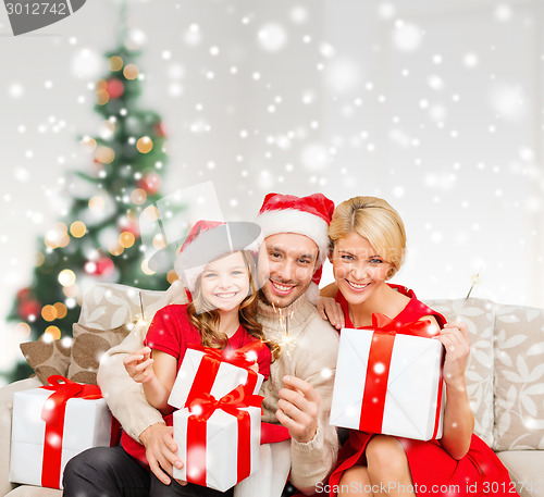 Image of smiling family holding many gift boxes