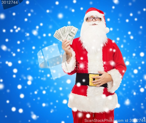 Image of man in costume of santa claus with dollar money