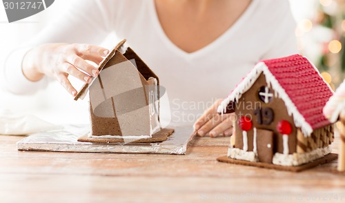 Image of close up of woman making gingerbread houses