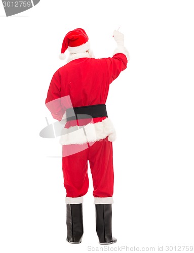 Image of man in costume of santa claus writing something