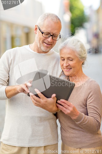 Image of senior couple photographing on city street