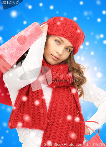 Image of smiling young woman with shopping bags