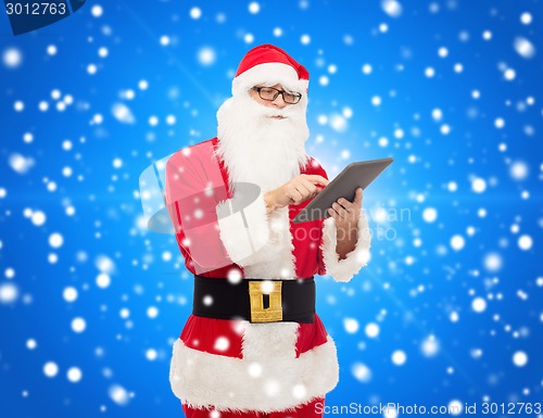 Image of man in costume of santa claus with tablet pc