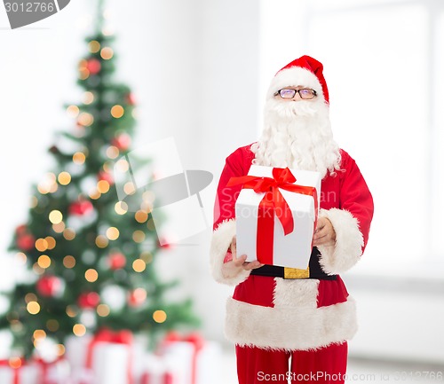 Image of man in costume of santa claus with gift box