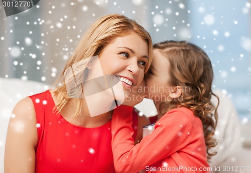 Image of happy mother and girl whispering into ear