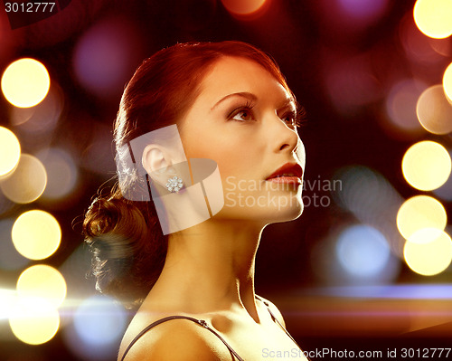 Image of woman in evening dress wearing diamond earrings