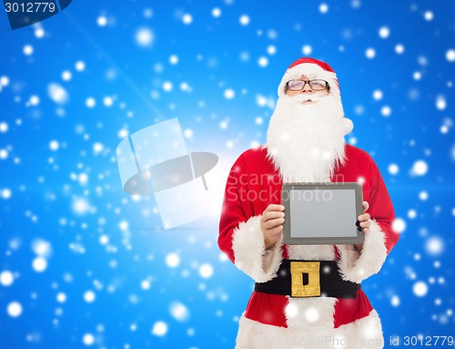 Image of man in costume of santa claus with tablet pc