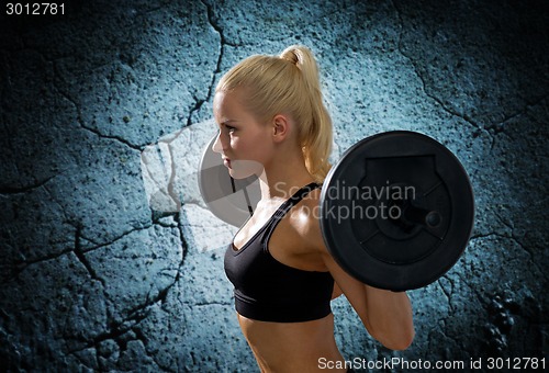 Image of sporty woman exercising with barbell