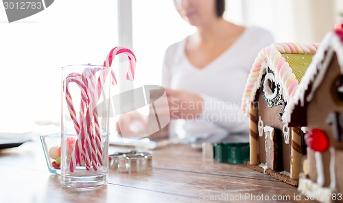 Image of close up of woman making gingerbread houses