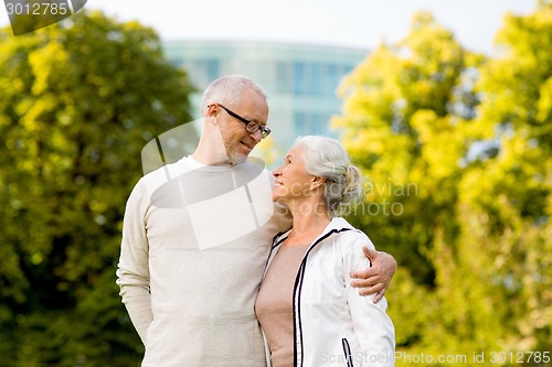 Image of senior couple hugging in city park
