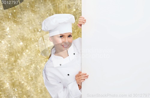 Image of smiling female chef with white blank board