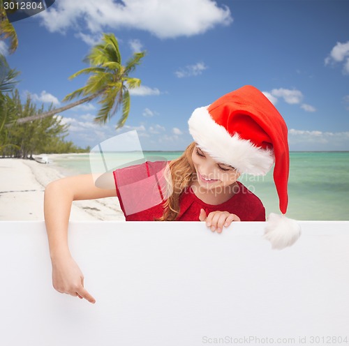 Image of girl in santa helper hat with blank white board