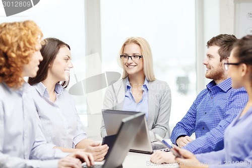 Image of smiling team with laptop and table pc computers