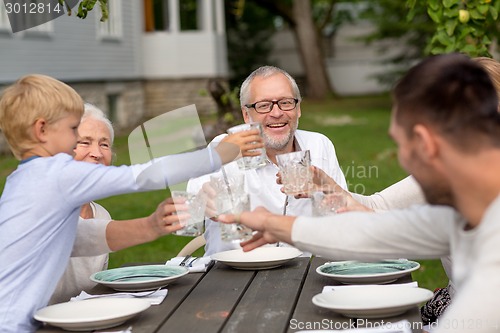 Image of happy family having holiday dinner outdoors