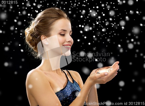 Image of smiling woman in evening dress with diamond