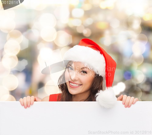 Image of woman in santa helper hat with blank white board