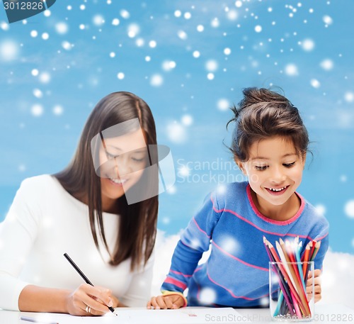 Image of mother and daughter with coloring pencils indoors