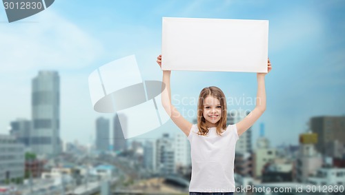 Image of smiling little girl holding blank white board