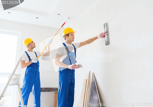 Image of group of builders with tools indoors