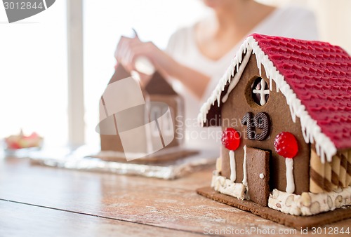 Image of close up of woman making gingerbread houses