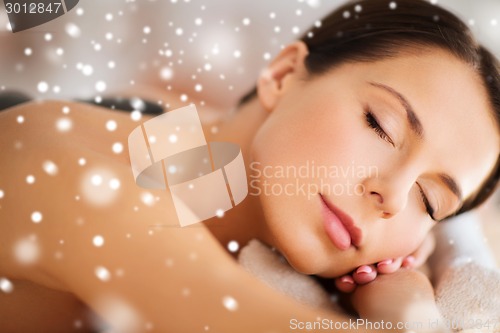 Image of woman in spa salon with hot stones