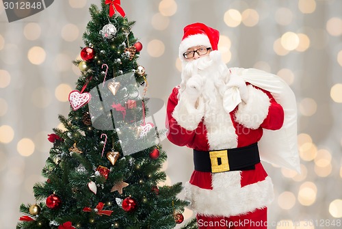 Image of santa claus with bag and christmas tree