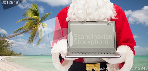Image of close up of santa claus with laptop