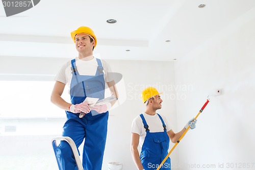 Image of group of builders with tools indoors