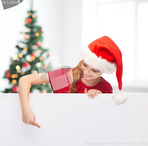 Image of girl in santa helper hat with blank white board