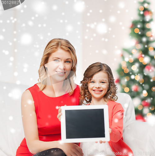 Image of mother and daughter with tablet pc at home