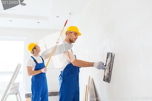 Image of group of builders with tools indoors