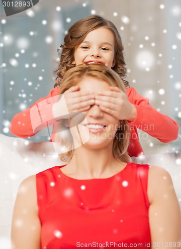 Image of happy mother and daughter having fun at home