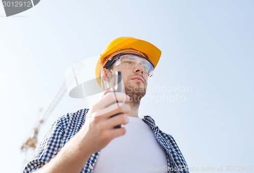 Image of builder in hardhat with radio
