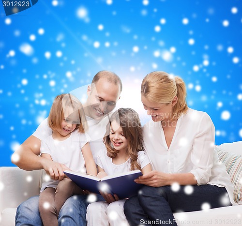 Image of happy family with book at home