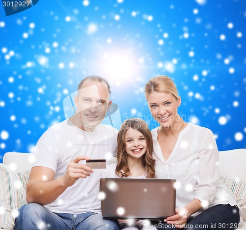 Image of happy family with laptop computer and credit card