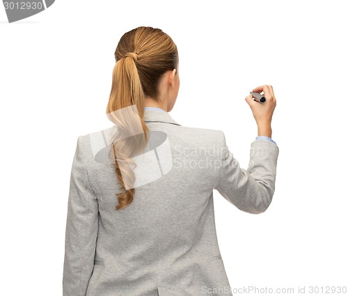 Image of businesswoman or teacher with marker from back